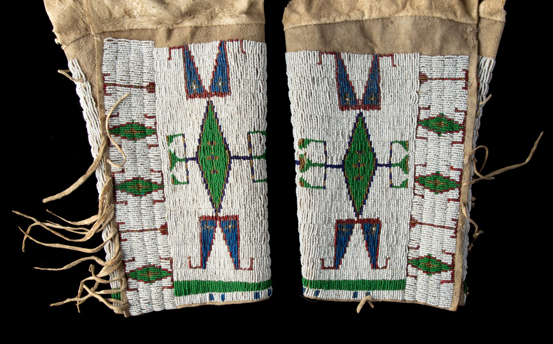 A PAIR OF LAKOTA BEADED WOMAN'S LEGGINGS CIRCA 1890