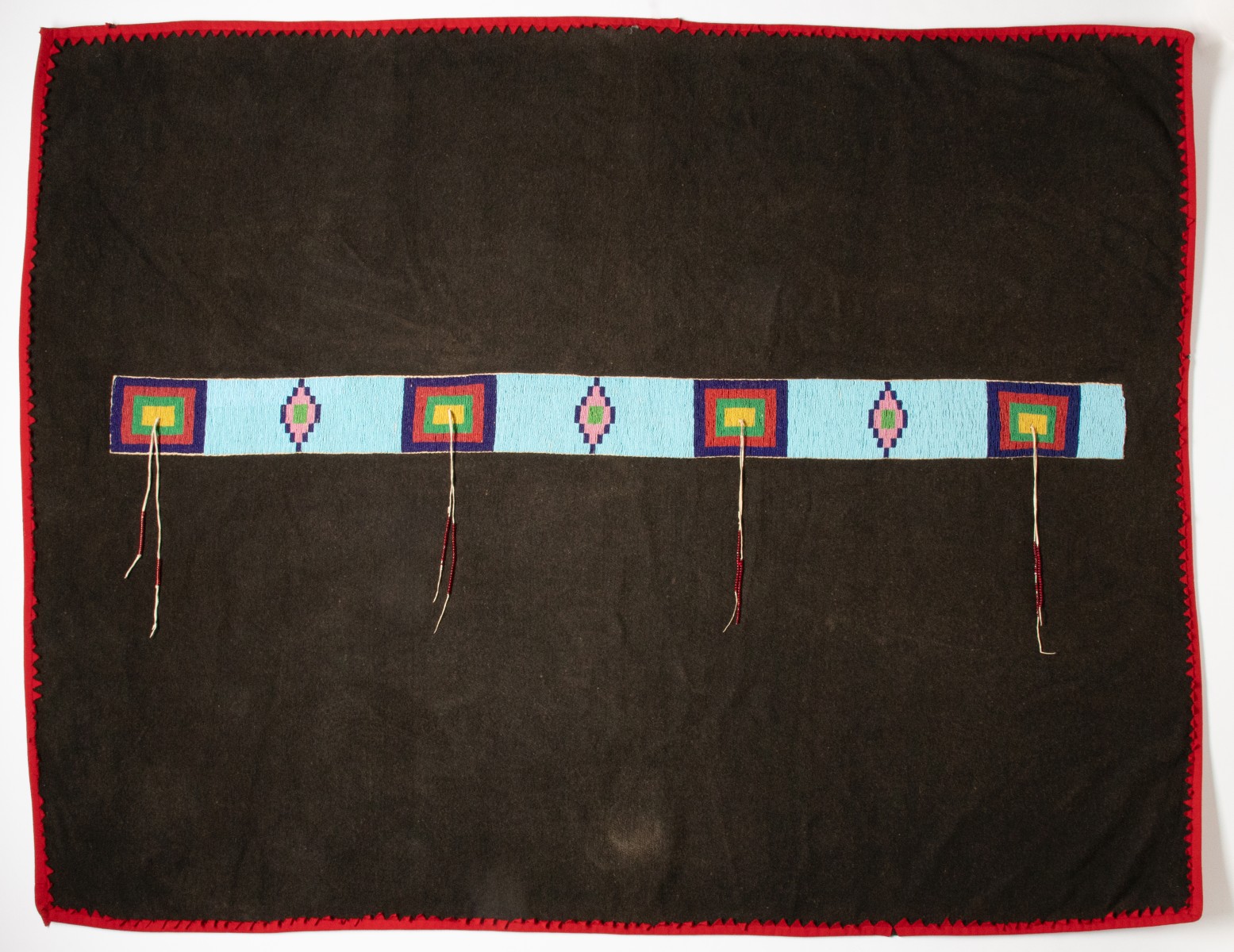 A NORTHERN PLAINS BLANKET WITH BEADED STRIP