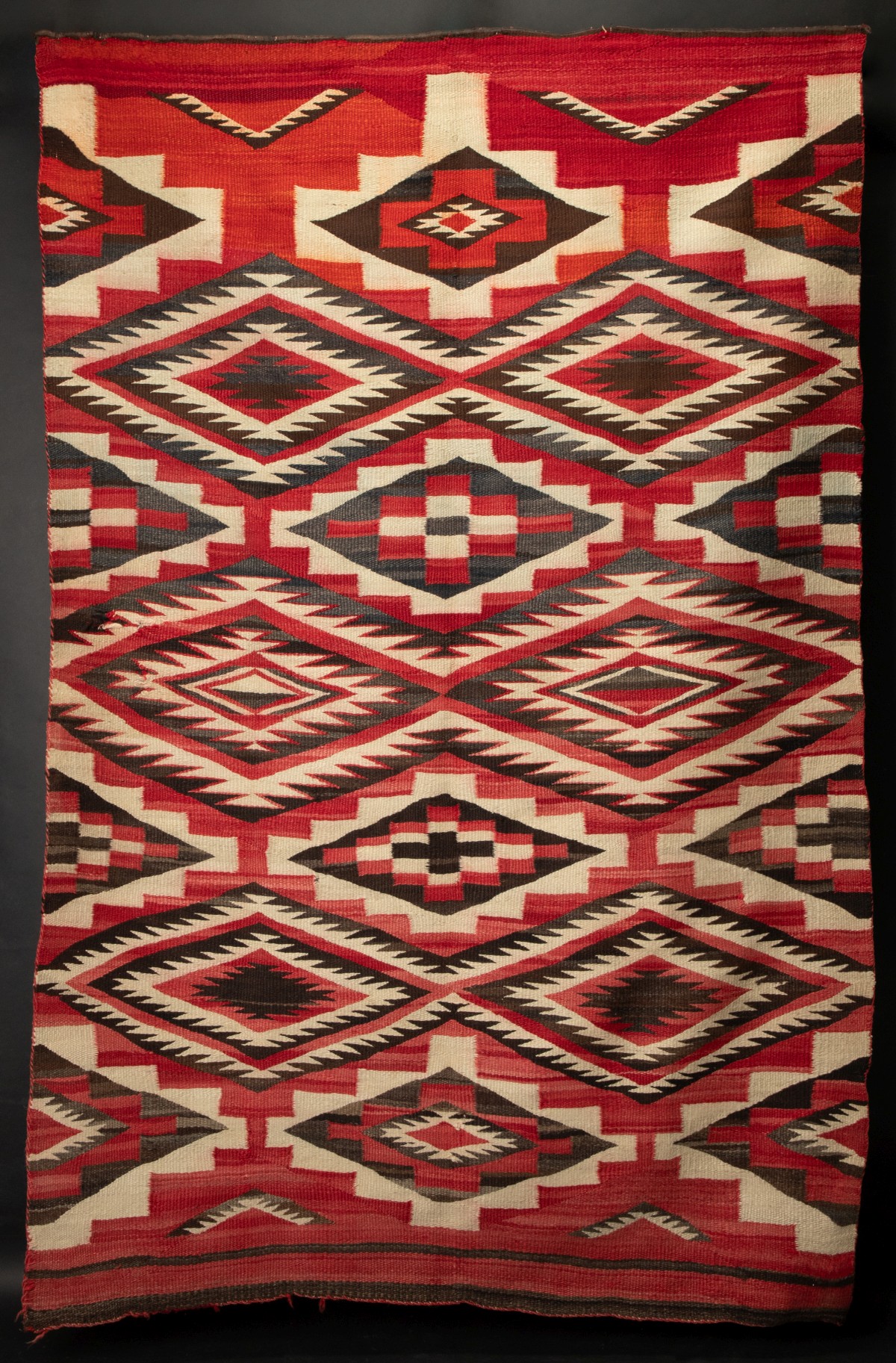 A NAVAJO RUG WITH STEPPED AND SERRATED DIAMONDS