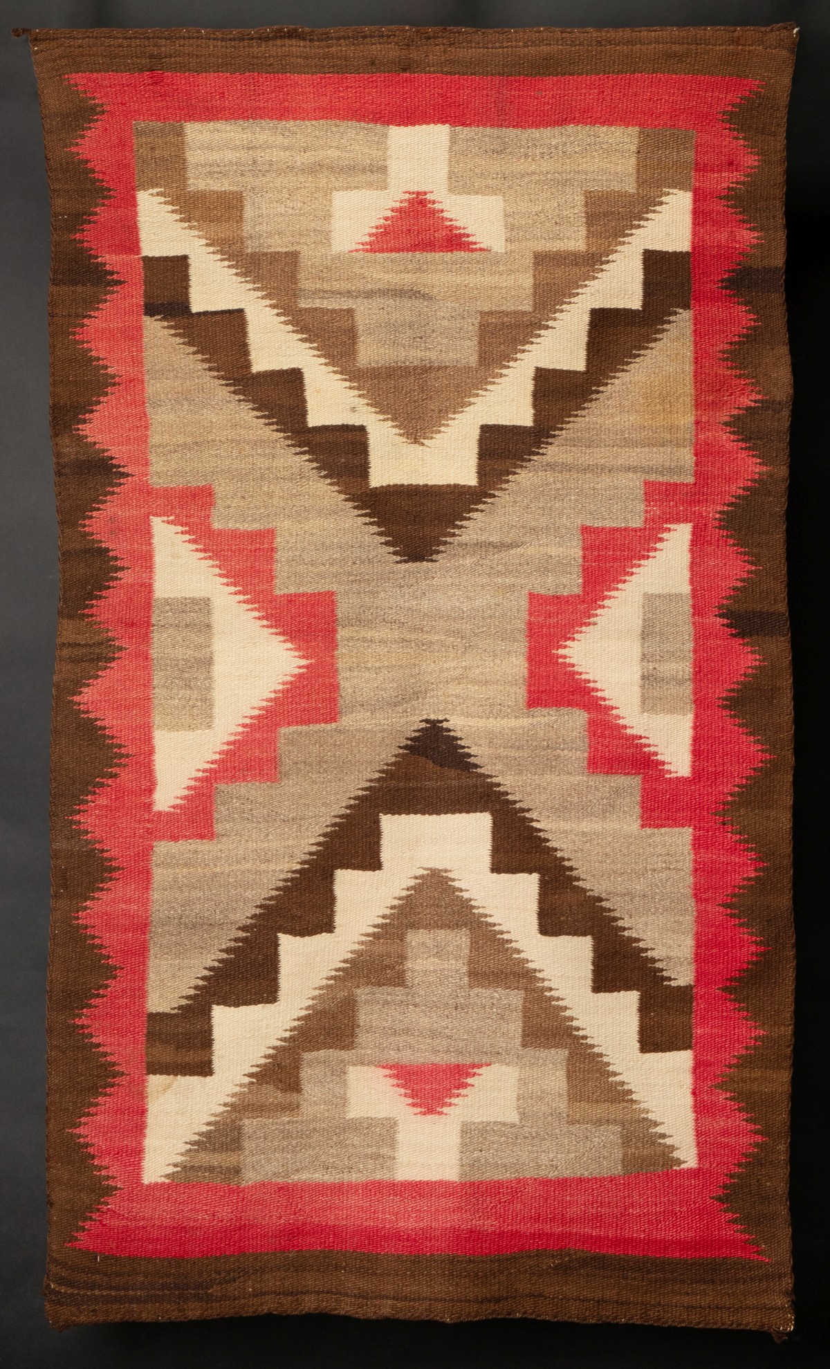 A FOUR COLOR NAVAJO RUG WITH SERRATED DESIGNS