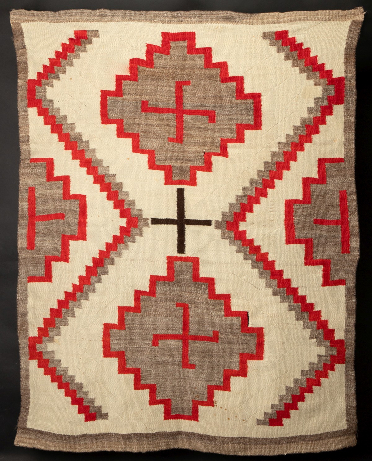 A NAVAJO RUG WITH STEPPED DIAMONDS AND WHIRLING LOGS