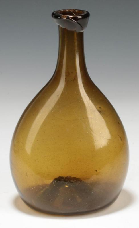 A 19TH CENTURY AMERICAN FREE BLOWN CHESTNUT FLASK