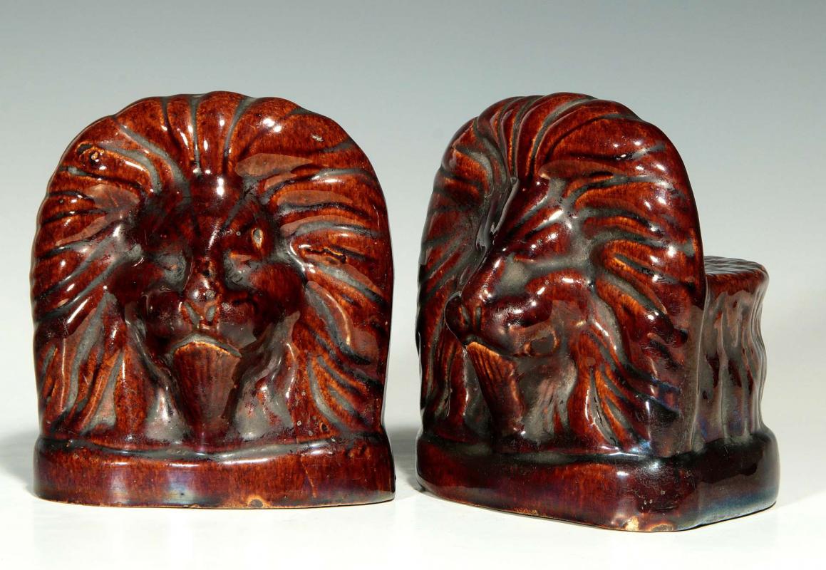 A PAIR ROCKINGHAM GLAZE POTTERY LION WINDOW STOPS