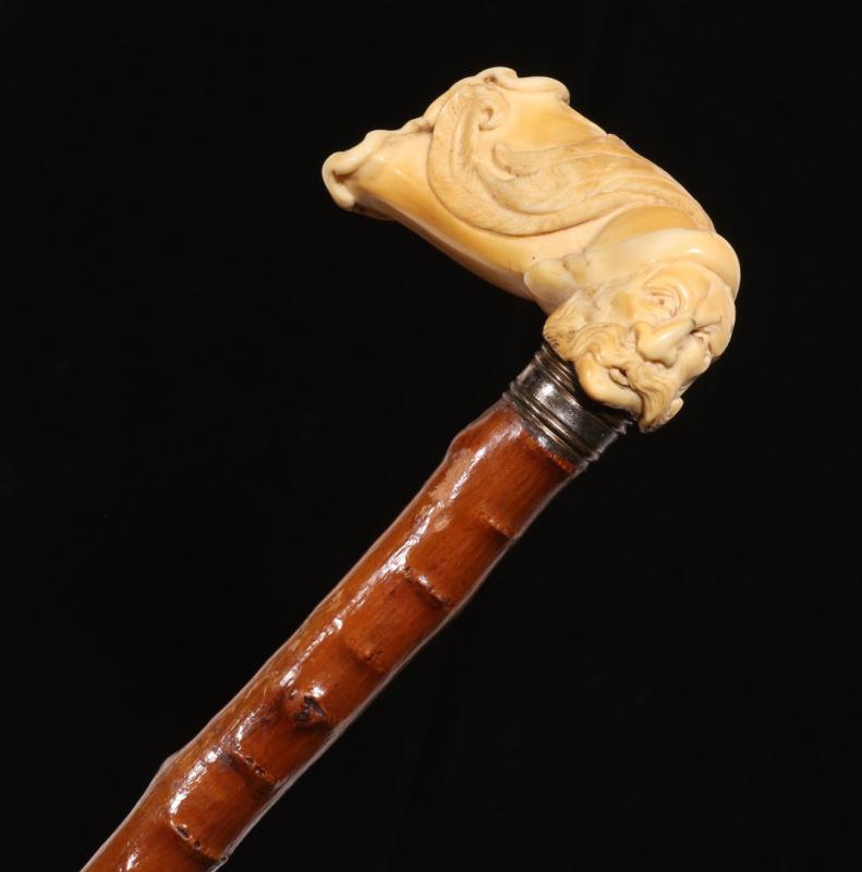 A 19TH C. CANE WITH UNUSUAL RUSTIC SHAFT & IVORY