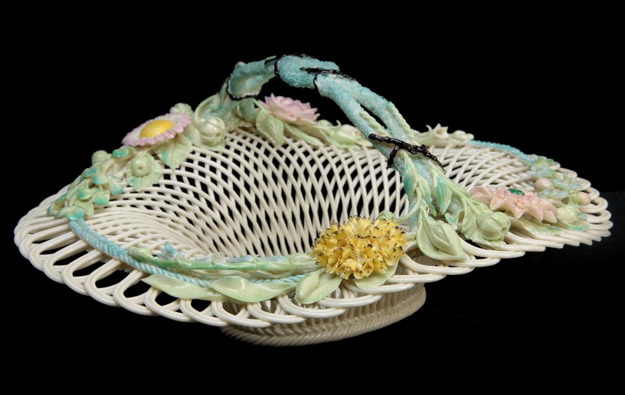 AN IRISH BELLEEK FOUR STRAND BASKET WITH HANDLE