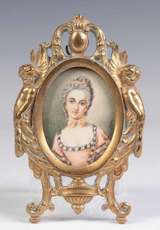 A PORTRAIT MINIATURE IN ORNATE BRONZE FRAME