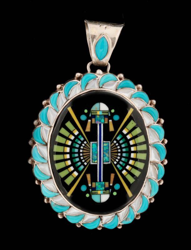 AN ELABORATE ZUNI SILVER AND SEMI-PRECIOUS PENDANT