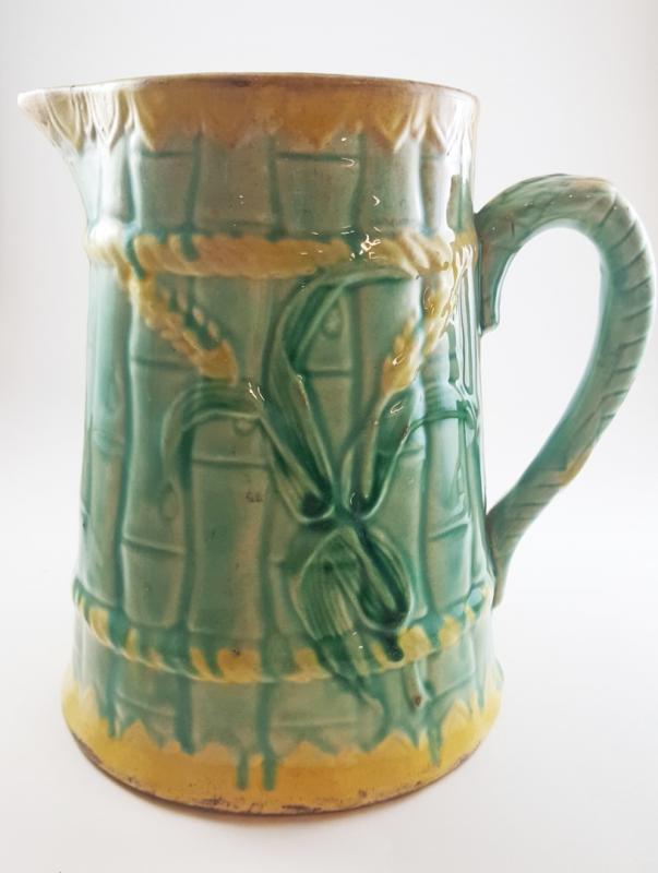 AN ANTIQUE MAJOLICA CORN PITCHER