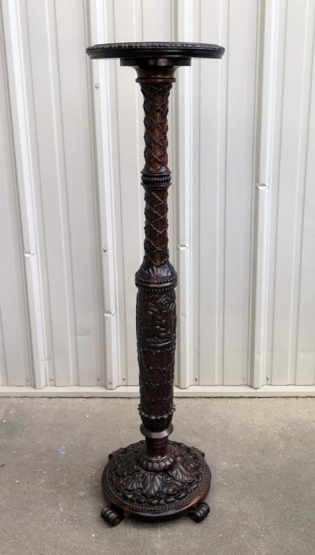 A TALL MAHOGANY CARVED PEDESTAL WITH CHERUBS