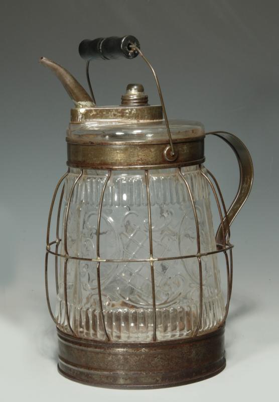 AN ORNATE ANTIQUE EMBOSSED GLASS KEROSENE FILLER 