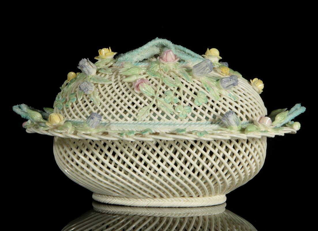 AN IRISH BELLEEK OVAL FOUR STRAND COVERED BASKET